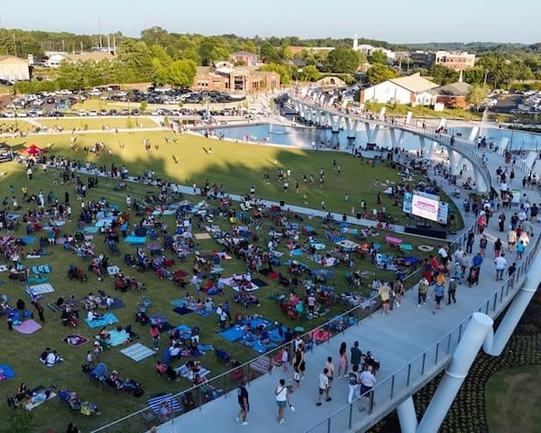 People gathered on the lawn at Suwanee's new Town Center on Main and DeLay Nature Park during its grand opening celebration on August 24, 2024. (Photo Courtesy of Lee Heard)