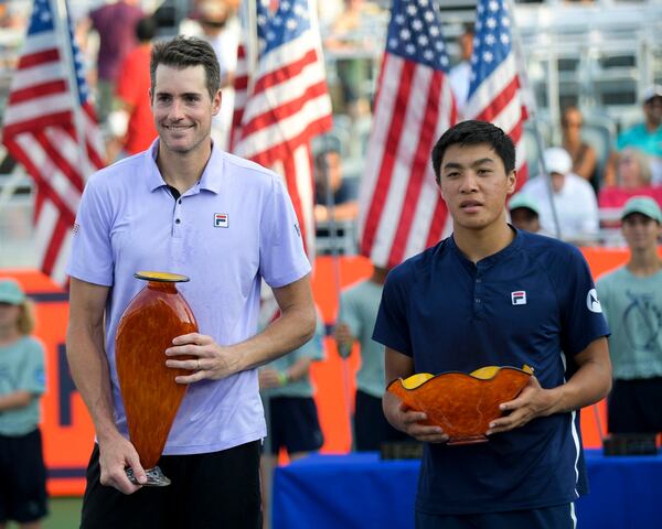 U.S. tennis players John Isner (left) and Brandon Nakashima pose with their trophies after competing in the Truist Atlanta Open Sunday, Aug. 1, 2021 at Atlantic Station in Atlanta. Isner won his sixth Atlanta Open. (Daniel Varnado/For the AJC)