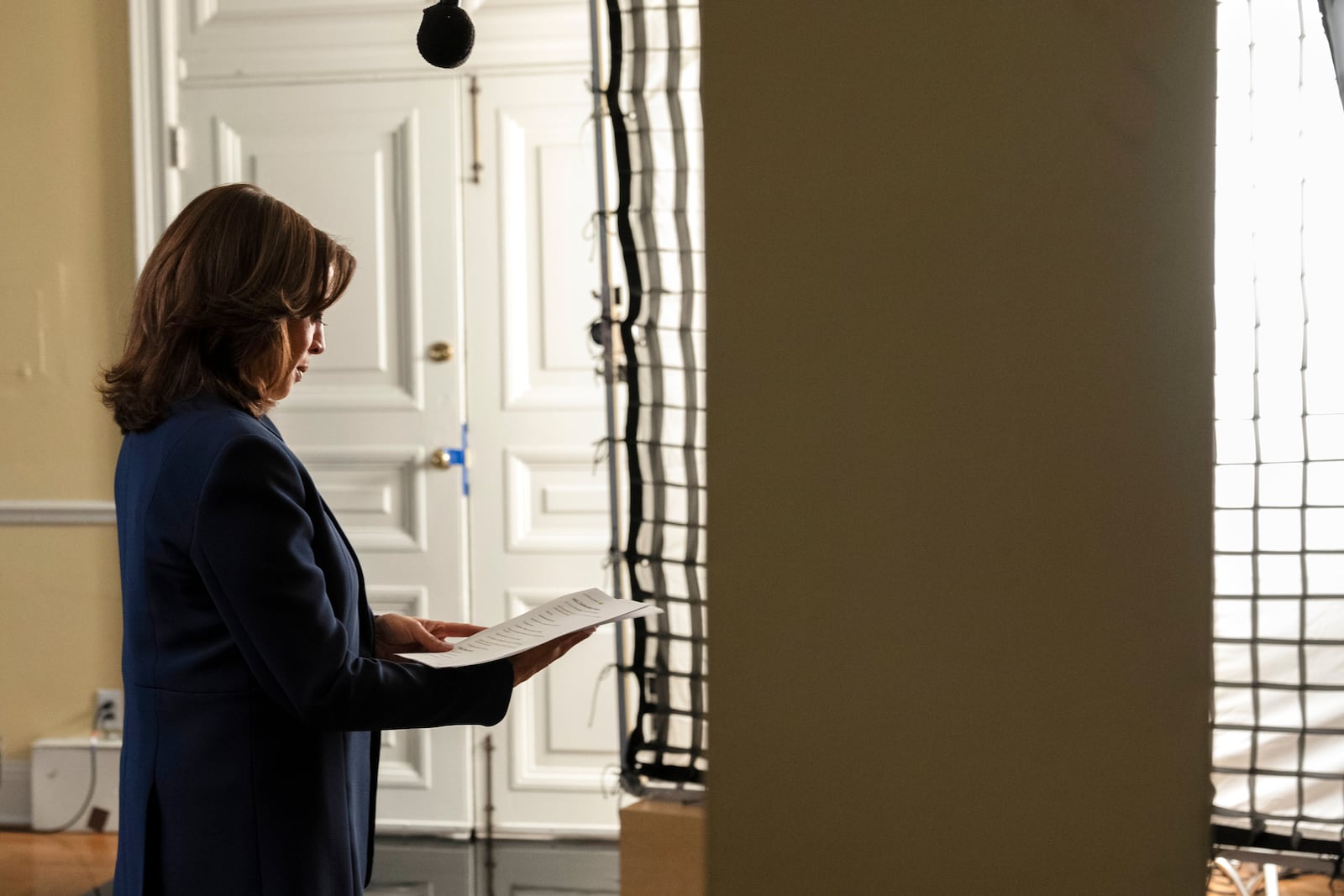 Democratic presidential nominee Vice President Kamala Harris reads over a copy of the script while recording a campaign video, "direct to camera," Tuesday, Oct. 29, 2024, in Washington, ahead of her speech on the ellipse. (AP Photo/Jacquelyn Martin)