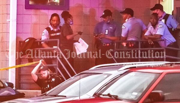 Police speak with Brinks employees outside the company's Atlanta offices on Huff Road.