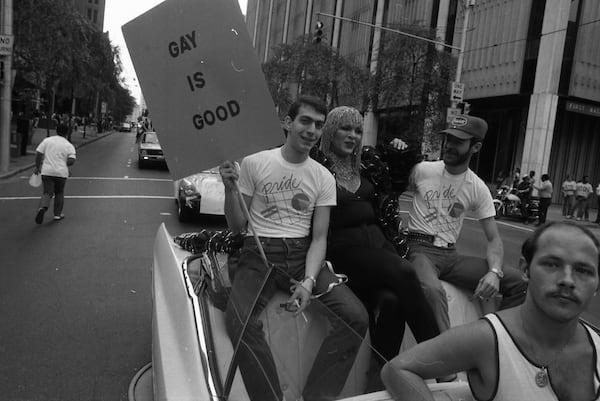 Gay pride participants ride in a convertible during a gay pride march in Atlanta, Georgia on June 21, 1980. Photo: KENNETH WALKER / THE ATLANTA JOURNAL-CONSTITUTION