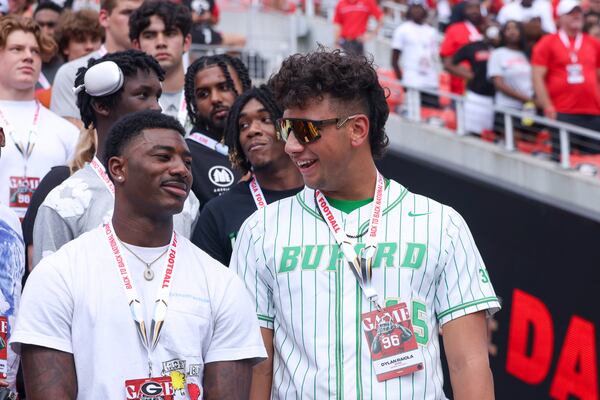 Buford quarterback Dylan Raiola, center, talks with Cass wide receiver Sacovie White as they visit Georgia during their game against Ball State at Sanford Stadium, Saturday, September 9, 2023, in Athens. Georgia won 45-3. (Jason Getz / Jason.Getz@ajc.com)