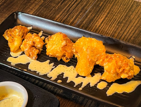 Tempura-like cauliflower served at Arepa Grill Kitchen & Wine shows off the kitchen's golden touch with the deep fryer. (Henri Hollis/henri.hollis@ajc.com)