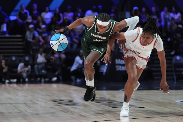 Rose guard Brittney Sykes, left, drives forward defended by Laces guard Tiffany Hayes, in their Unrivaled 3-on-3 basketball semifinal, Sunday, March 16, 2025, in Medley, Fla. (AP Photo/Rebecca Blackwell)