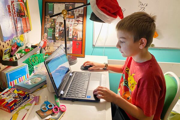 This April 9, 2020, photo released by Kara Illig shows her son, Eli Illig, 10, on his computer in Ebensburg, Pa. The frustration of parents is mounting as more families across the U.S. enter their second or even third week of total distance learning, and some say it will be their last. (Kara Illig via AP)