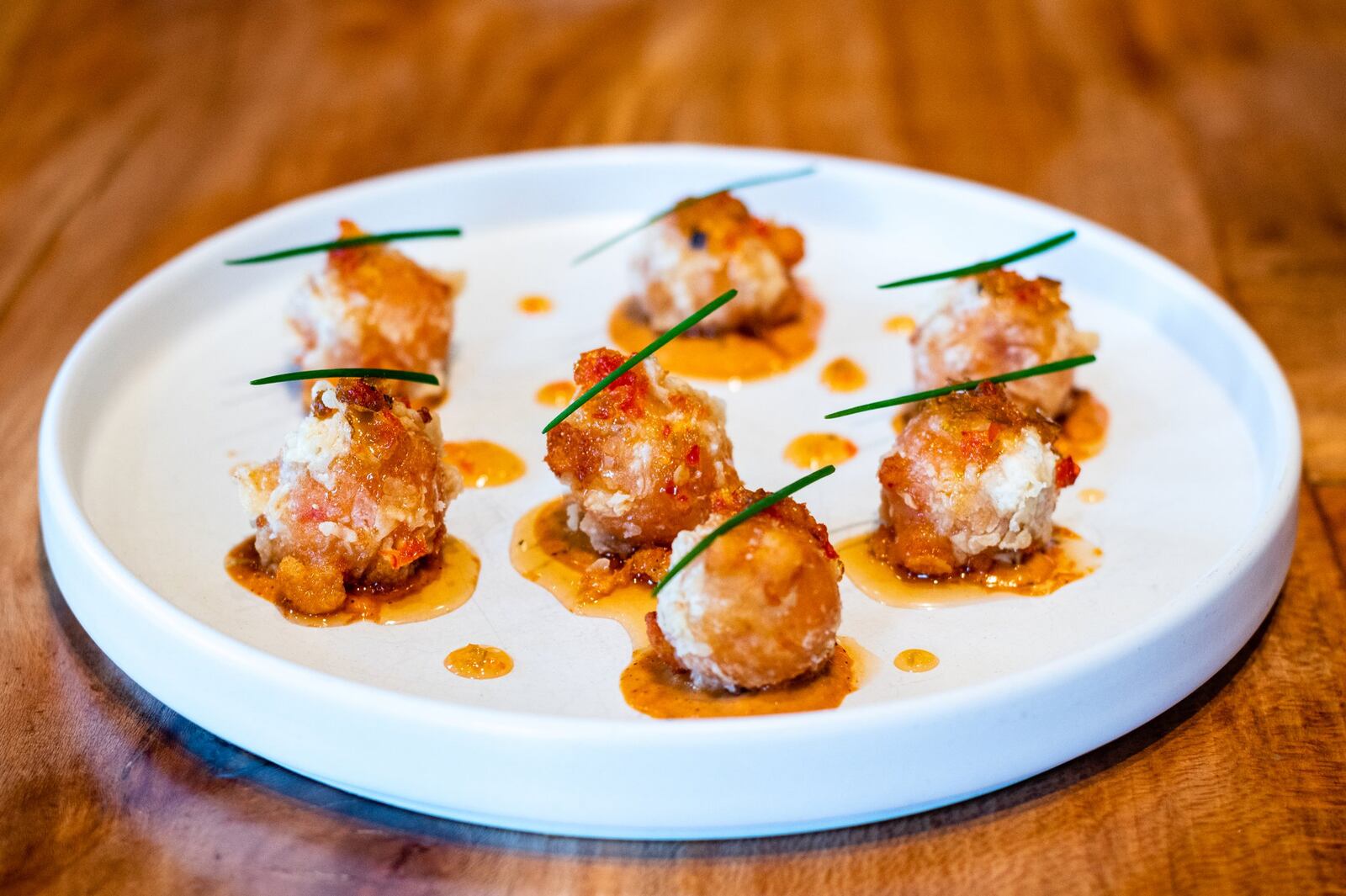 Watershed’s Pimento Cheese Fritters are made from a combination of Emmental Swiss cheese, Tillamook cheddar, pepper jelly and comeback sauce. CONTRIBUTED BY HENRI HOLLIS