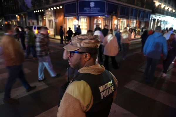 Spc. Nelson Harrison, of the Louisiana National Guard, keeps a watchful eye on Bourbon Street in the French Quarter, Thursday, Jan. 2, 2025 in New Orleans. (AP Photo/George Walker IV)