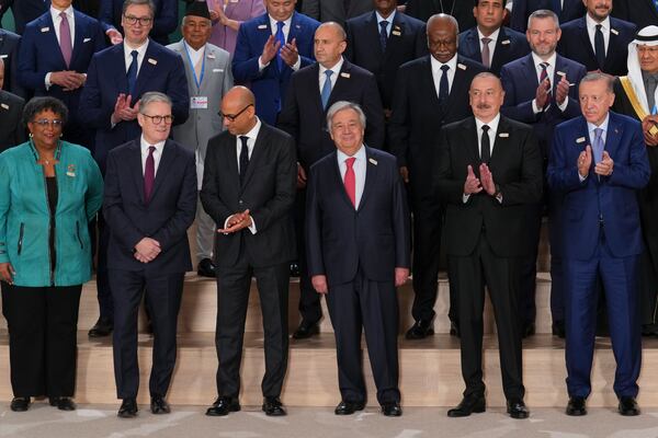 Barbados Prime Minister Mia Mottley, United Kingdom Prime Minister Keir Starmer, Simon Stiell, United Nations climate chief, Antonio Guterres, United Nations secretary-general, Ilham Aliyev, Azerbaijan president and Turkey President Recep Tayyip front center, pose with others for a group photo at the COP29 U.N. Climate Summit, Tuesday, Nov. 12, 2024, in Baku, Azerbaijan. (AP Photo/Peter Dejong)