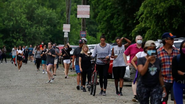 People wait in line to vote in the Georgia's primary election at Park Tavern on Tuesday, June 9, 2020, in Atlanta.