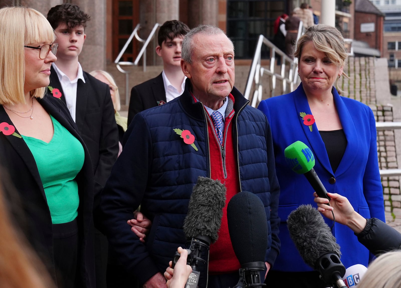 Patrick O'Hara, center, talks to the media outside the Newcastle Crown Court, in Newcastle, England, Wednesday, Nov. 6, 2024 where Dr. Thomas Kwan, was sentenced to 31 years and five months after he attempted to murder Mr O'Hara, who was his mother's partner, with a poisoned fake Covid jab whilst disguised as a nurse. (Owen Humphreys/PA via AP)