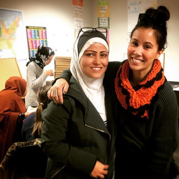 Volunteer Kelly Daniels and Asma Rafi, a native of Afghanistan, during a free citizenship prep class sponsored by IRC in Atlanta. Daniels and Bob Gordon lead the classes. Rafi took the class in 2016 and is now a U.S. citizen. Courtesy of the International Rescue Committee