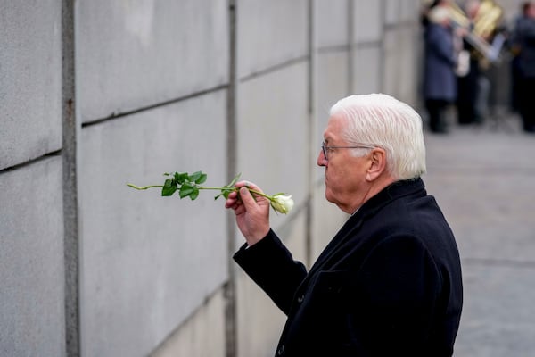 German President Frank-Walter Steinmeier, left, attends a flower laying ceremony on occasion of the 35th wall anniversary at the grounds of the Berlin Wall Memorial, Berlin, Germany, Saturday, Nov.9, 2024. (AP Photo/Ebrahim Noroozi)