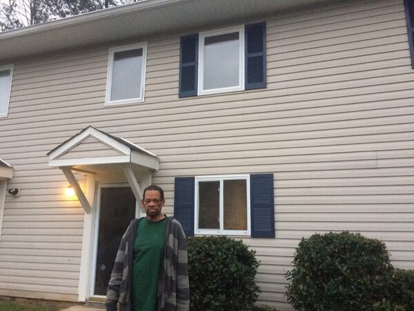 Joseph Pugh outside the apartment where he has lived for 10 years, and which he now can barely afford. Photo by Bill Torpy