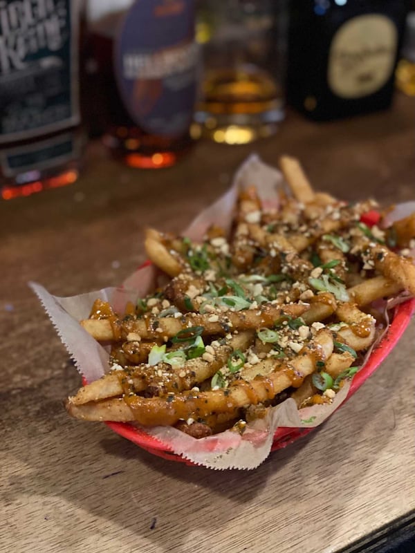 The loaded fries from Poor Hendrix include spicy sesame sauce, ground peanuts, scallions and Japanese rice seasoning. Courtesy of Poor Hendrix