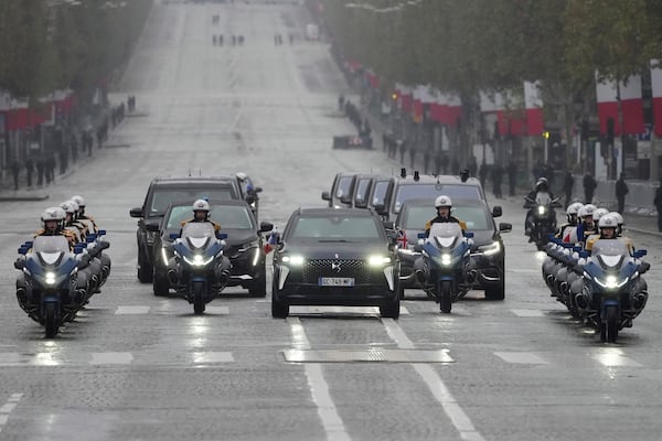 The motorcade carrying French President Emmanuel Macron and British Prime Minister Keir Starmer drive up the Champs Elysees avenue Monday, Nov. 11, 2024 in Paris, during ceremonies marking the 106th anniversary of the Armistice, a celebration of their countries' friendship, as nations across the world pay tribute to their fallen soldiers in World War I. (AP Photo/Michel Euler, Pool)