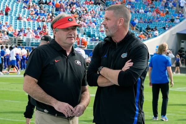 Georgia head coach Kirby Smart, left, greets Florida head coach Billy Napier before an NCAA college football game, Saturday, Nov. 2, 2024, in Jacksonville, Fla. (AP Photo/John Raoux)