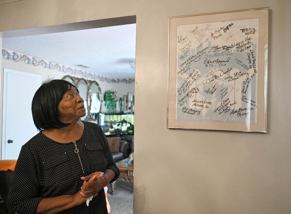 For 35 years, Sally Hollis has proudly displayed on her dining room wall a framed poster signed by former first couple Jimmy and Rosalynn Carter and other volunteers who worked on her house in Atlanta. The home was part of an annual Habitat for Humanity International building blitz led by the Carters. (Hyosub Shin / Hyosub.Shin@ajc.com)