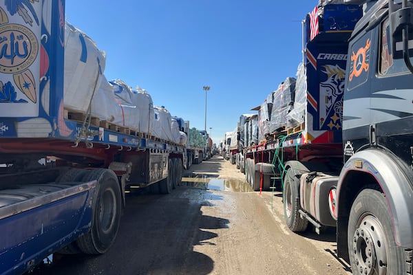 Trucks line up at the Egyptian side of the Rafah border crossing between Egypt and the Gaza Strip after Israel blocked the entry of aid trucks into Gaza, Sunday, March 2, 2025. (AP Photo/Mohamed Arafat)