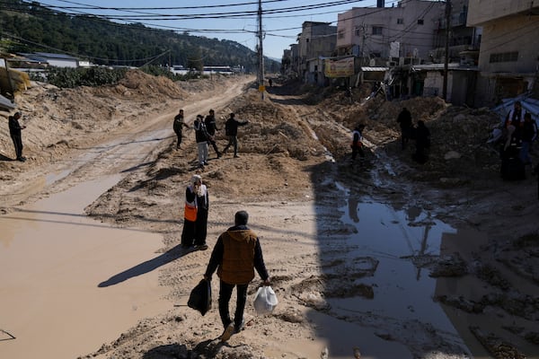 Residents of the West Bank urban refugee camp of Nur Shams evacuate their homes and carry their belongings as the Israeli military continues its operation in the area on Wednesday, Feb. 26, 2025. (AP Photo/Majdi Mohammed)