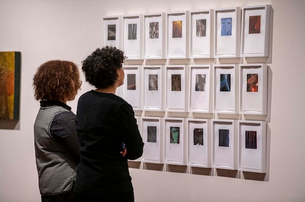 Onlookers observe watercolor paintings at the opening reception of Amanda Williams' "We Say What Black This Is at Spelman College Museum of Fine Art" on Friday, February 7, 2025.