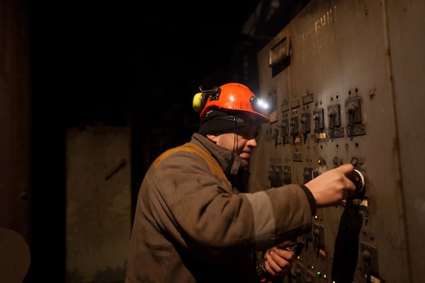 A worker repairs equipment at DTEK's power plant after a recent Russian missile attack in Ukraine, Nov. 28, 2024. (AP Photo/Evgeniy Maloletka)