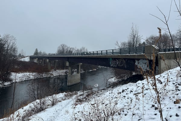 Rain and snow falls near the Presumpscot River in Falmouth, Maine as officials are watching for flooding on New England rivers, Wednesday, Dec. 11, 2024. (AP Photo/Patrick Whittle)