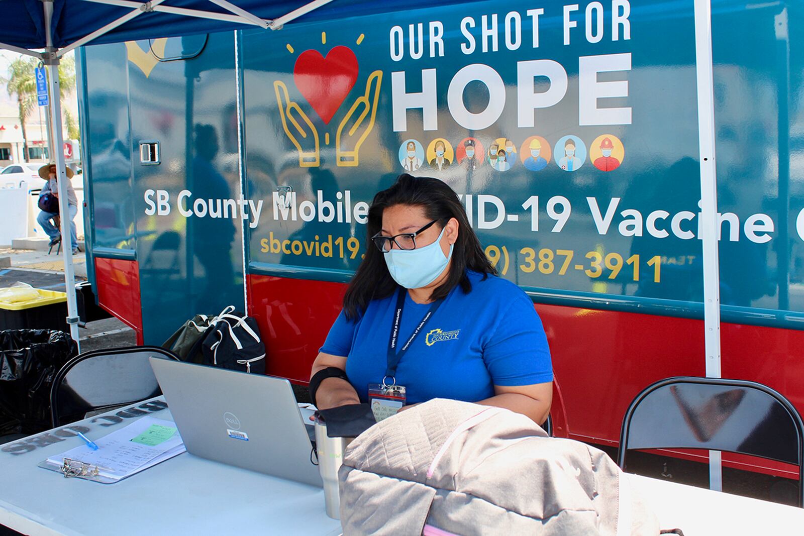 Nancy Garcia, a San Bernardino County employee who managed the July 15 pop-up COVID-19 vaccine clinic in San Bernardino, California, says she works a "crazy schedule" to get people vaccinated. Garcia, who lost her mother and a cousin to COVID, says she's deep in the throes of grief. (Anna Almendrala/Kaiser Health News/TNS)