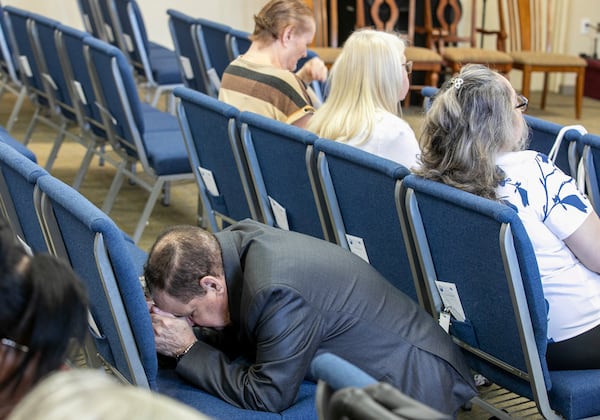 A congregant kneels in prayer at the Centro Cristiano El Pan de Vida, a mid-size Church of God of Prophecy congregation, in Kissimmee, Fla., Sunday, Feb. 2, 2025. (AP Photo/Alan Youngblood)