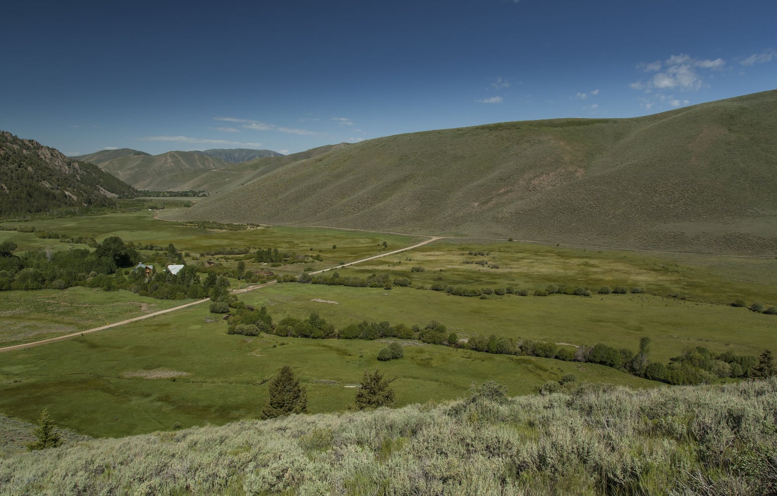 500-acre property has log cabins, mountain views