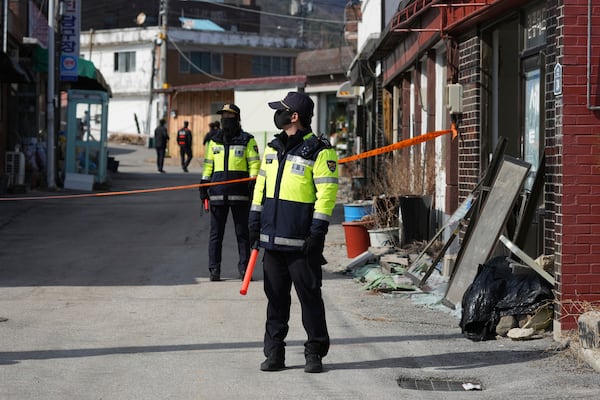 Police officers control damaged area near the site of an accidental bombing in Pocheon, South Korea, Thursday, March 6, 2025. (AP Photo/Lee Jin-man)