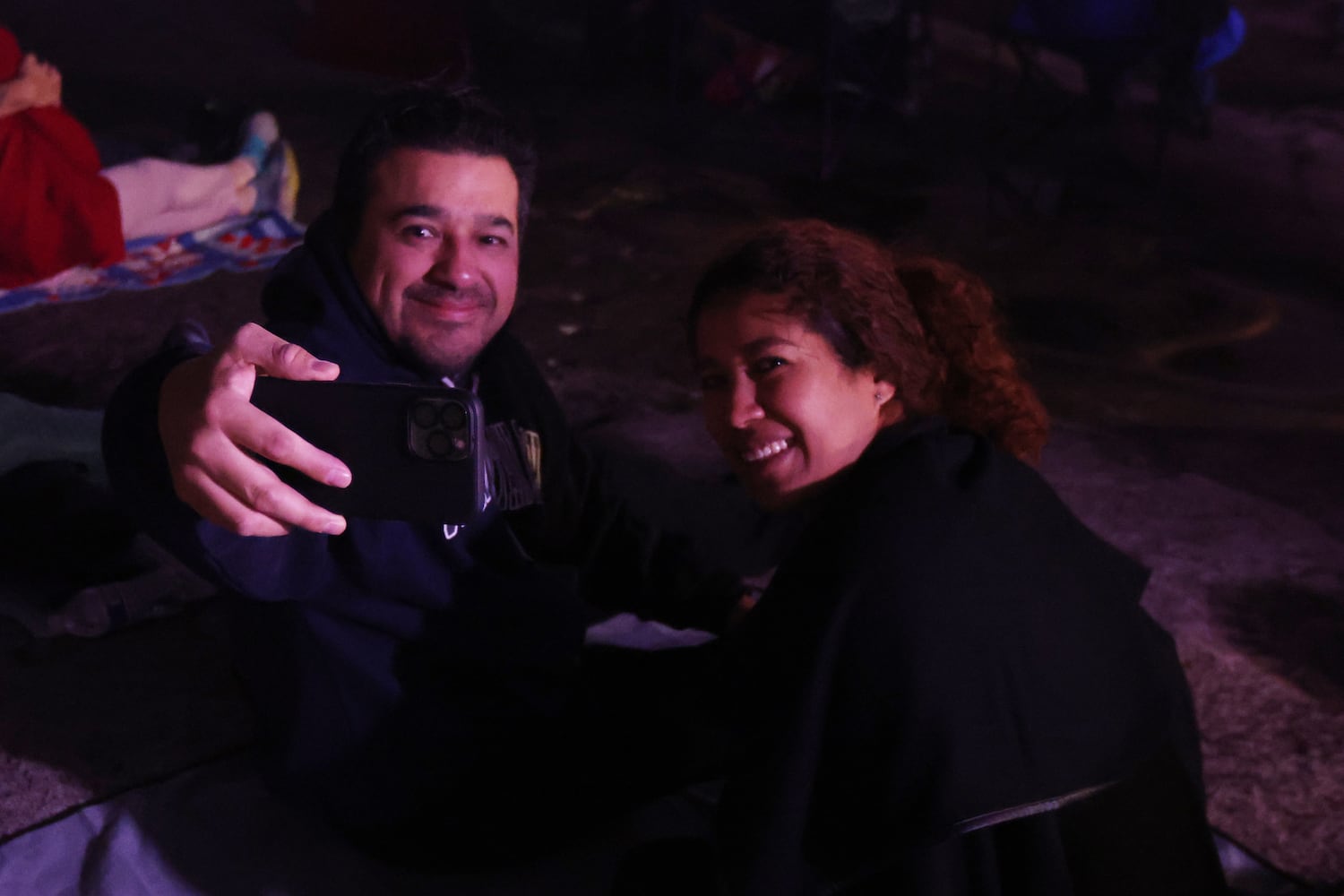 Jesse Vega takes a selfie with Carolina Serrano at the top of Stone Mountain during the 76th Easter Sunrise Service on Sunday, April 17, 2022. Miguel Martinez/miguel.martinezjimenez@ajc.co