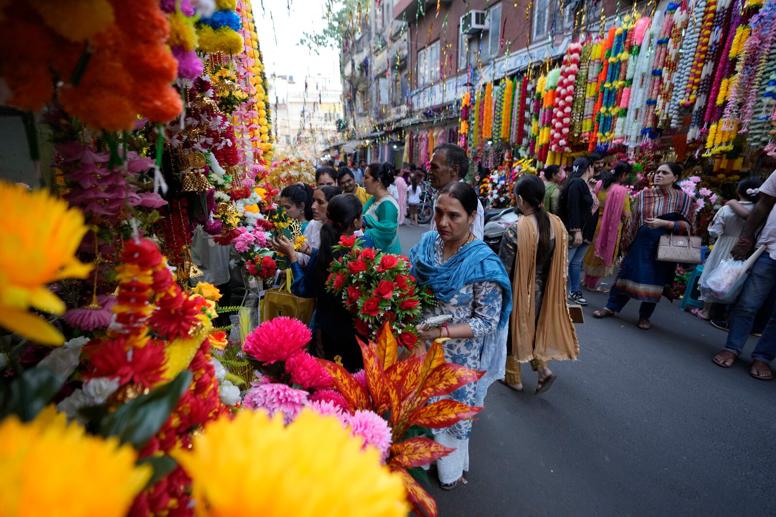 People shop on the eve of Diwali, the Hindu festival of lights, in Jammu, India, Wednesday, Oct. 30, 2024.Diwali is one of Hinduism's most important festivals, dedicated to the worship of the goddess of wealth Lakshmi. (AP Photo/Channi Anand)