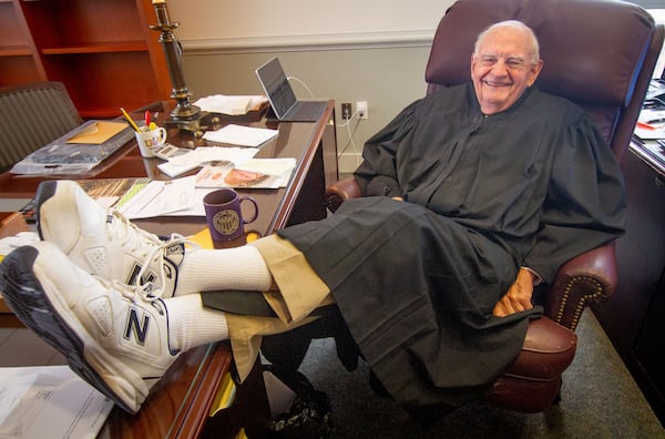 DeKalb County Superior Court Judge Clarence Seeliger shows off his tennis shoes in his DeKalb County Courthouse office in Decatur November 4, 2020. Seeliger will be retiring at the end of the year after 40 years on the bench.  STEVE SCHAEFER FOR THE ATLANTA JOURNAL-CONSTITUTION