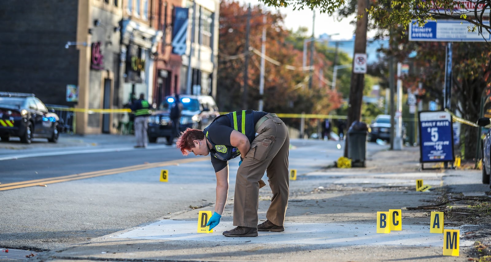 The GBI collects evidence outside a downtown Atlanta lounge following a Nov. 6 shootout that left two men dead and several others injured.  (John Spink / John.Spink@ajc.com)

