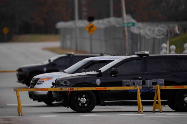 Police cars are parked outside of Indiana State Prison where, barring last-minute court action or intervention by Gov. Eric Holcomb, Joseph Corcoran, 49, convicted in the 1997 killings of his brother and three other people, is scheduled to be put to death by lethal injection before sunrise Tuesday, Dec. 17, 2024, in Michigan City, Ind. (AP Photo/Erin Hooley)