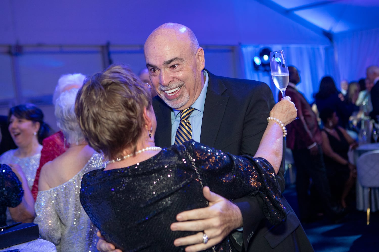 Delta Airlines celebrates its 100 year anniversary on Saturday, March 15, 2025 at the Delta Flight Museum.   JD Grimes, a retired flight attendant catches up with friends and the gala. (Jenni Girtman for The Atlanta Journal-Constitution)