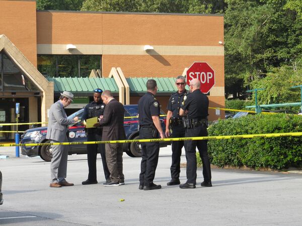 Police blocked off the shopping center's parking lot to investigate the deadly double shooting. 