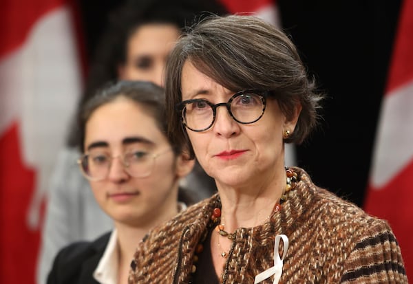 Gun control advocate and survivor of the 1989 Ecole Polytechnique massacre Nathalie Provost, right, speaks at a press conference on new measures to strengthen gun control as director of legal affairs at the National Association of Women and the Law, Suzanne Zaccour, listens in Ottawa, Ontario, on Thursday, Dec. 5, 2024. (Patrick Doyle/The Canadian Press via AP)