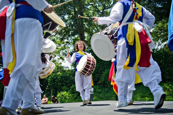 Jungha Kim (center) performs during the World Refugee Day celebration at the Clarkston Community Center in Clarkston on Saturday, June 21, 2014. The celebration included food, performances and a naturalization ceremony for 20 refugees and asylees from 12 different countries including Ghana, Iraq, Iran, Bosnia and Kenya. 