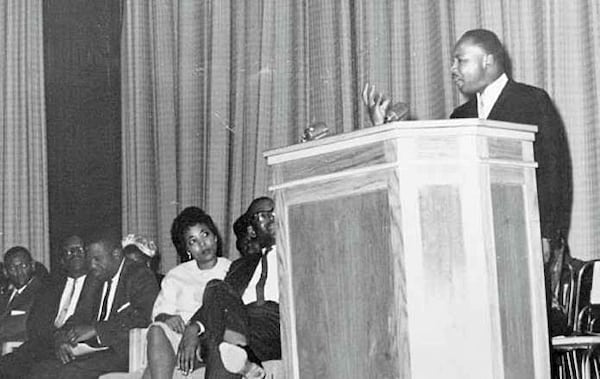 Dorothy Cotton as a young woman listens to a speech by Martin Luther King Jr.