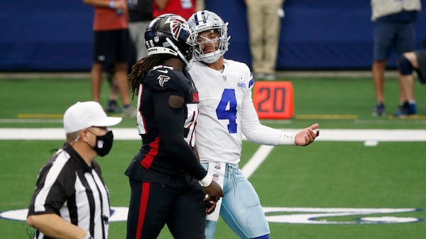 Cowboys quarterback Dak Prescott (4) exchanges words with Falcons defensive end Takk McKinley (98) between Sunday, Sept. 20, 2020, in Arlington, Texas. (Michael Ainsworth/AP)