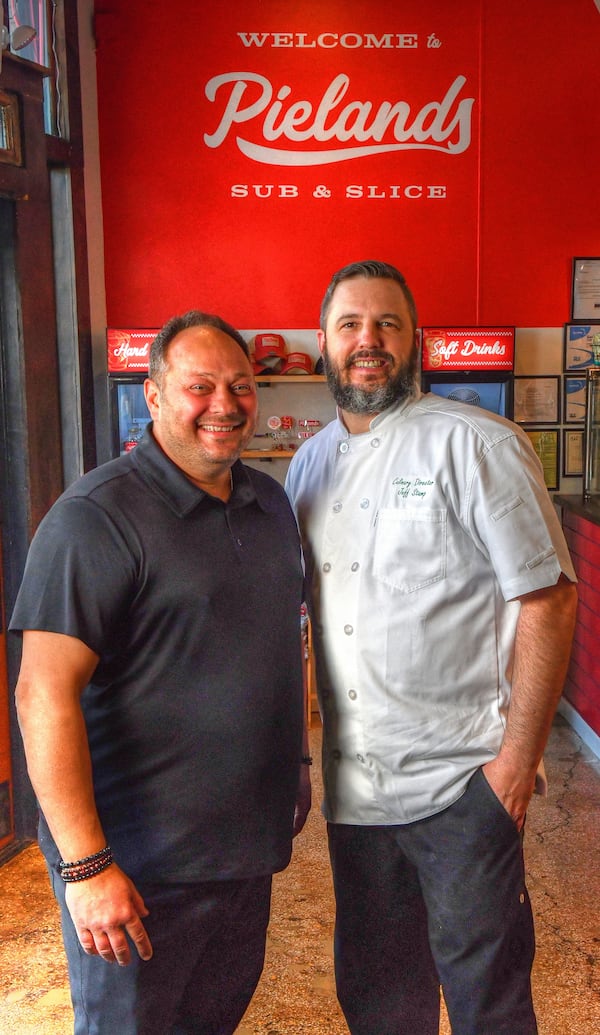 Pielands Sub & Slice owner Billy Streck (left) and culinary director Jeff Stamp pose for a team photo. Both came from families in New York state with pizza places. (Chris Hunt for The Atlanta Journal-Constitution)