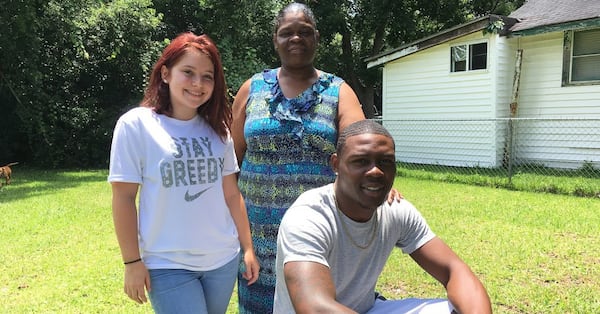 Former Georgia Tech running back Dedrick Mills with Zoe Raulerson and Mills' mom, Sharon Mills. (AJC photo)