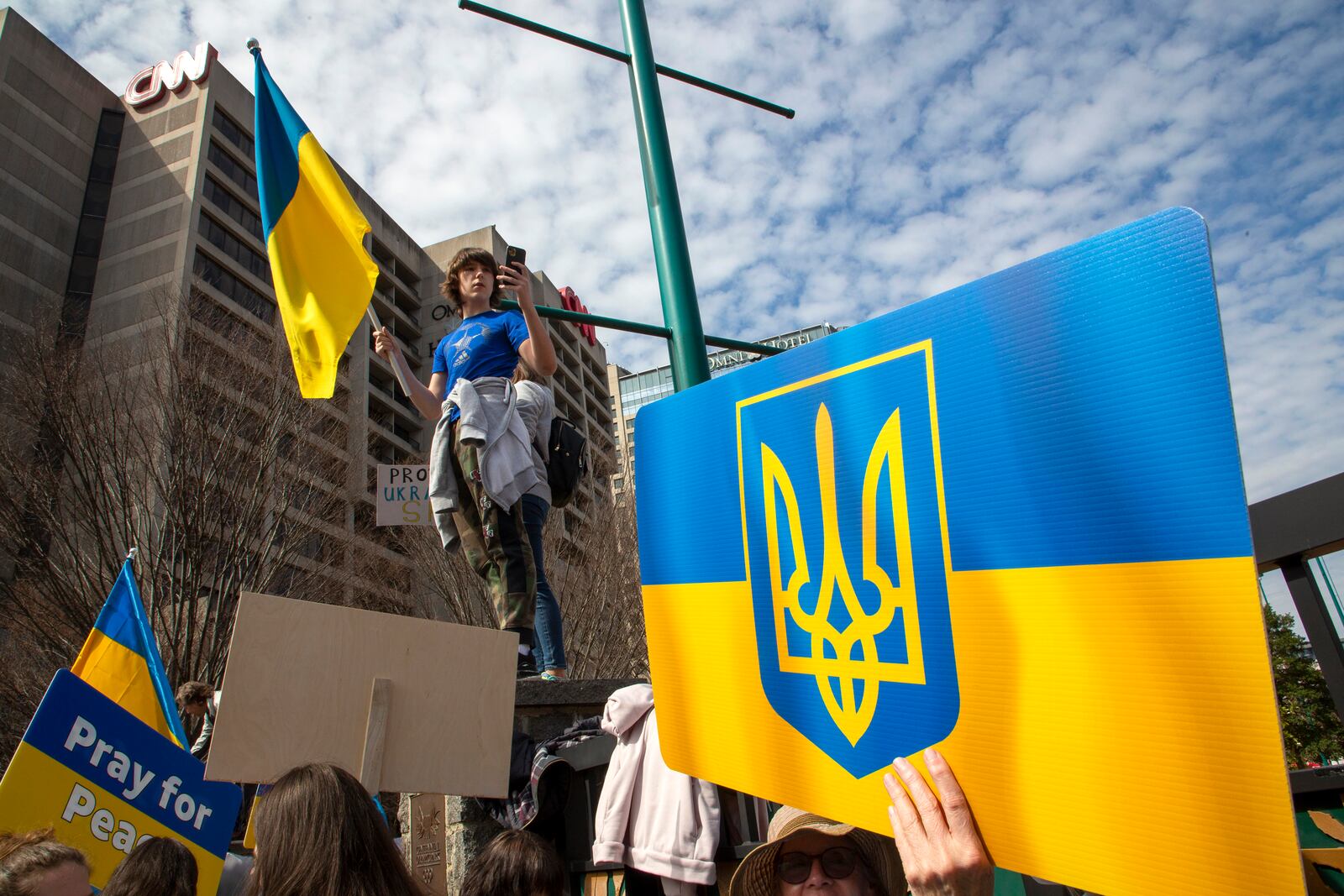 People show their support for Ukraine during a rally outside Centennial Olympic Park in Atlanta on Saturday, February 26, 2022.  STEVE SCHAEFER FOR THE ATLANTA JOURNAL-CONSTITUTION