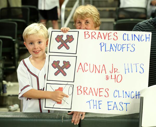 An Atlanta Braves fan holds a sign in honor of center fielder Ronald Acuna (not pictured) after the Braves' 6-0 win against the San Francisco Giants to clinch the NL East division at Sun Trust Park Friday, September 20, 2019 in Atlanta. (JASON GETZ/SPECIAL TO THE AJC)