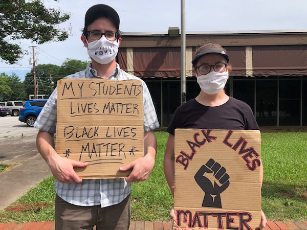 Elizabeth and Mark Hammontree, both 25, attended the rally Saturday in Avondale Estates. (Photo: Helena Oliviero/AJC)