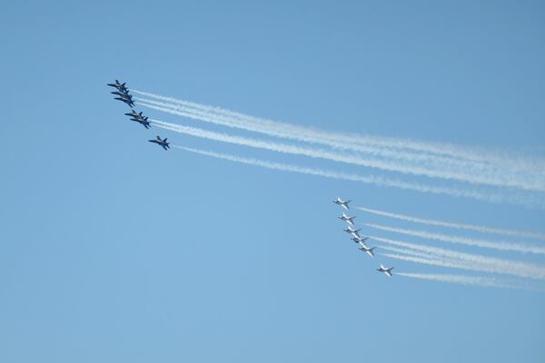 The Blue Angels, left, and the Thunderbirds fly over Atlanta Saturday to honor front-line COVID-19 responders and essential workers. (JASON GETZ/SPECIAL TO THE AJC)