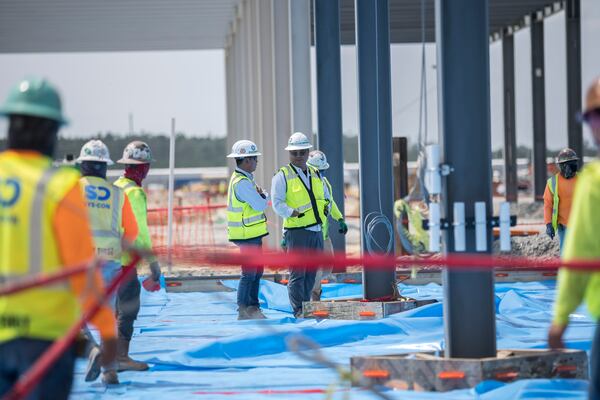 Workers prepare to pour the concrete floor of the assembly building on the Hyundai Metaplant site in Ellabell, Ga., on Monday, July 5, 2023. (Stephen B. Morton for the AJC)