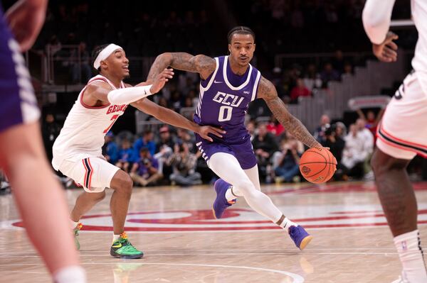 Grand Canyon guard Ray Harrison (0) dibbles the ball past Georgia guard Tyrin Lawrence (7) during the first half of an NCAA college basketball game, Saturday, Dec. 14, 2024, in Atlanta. (AP Photo/Kathryn Skeean)