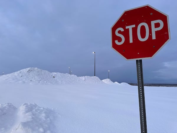 Snow is piled at a parking lot in Lowville, N.Y., Tuesday, Dec. 3, 2024. (AP Photo/Cara Anna)